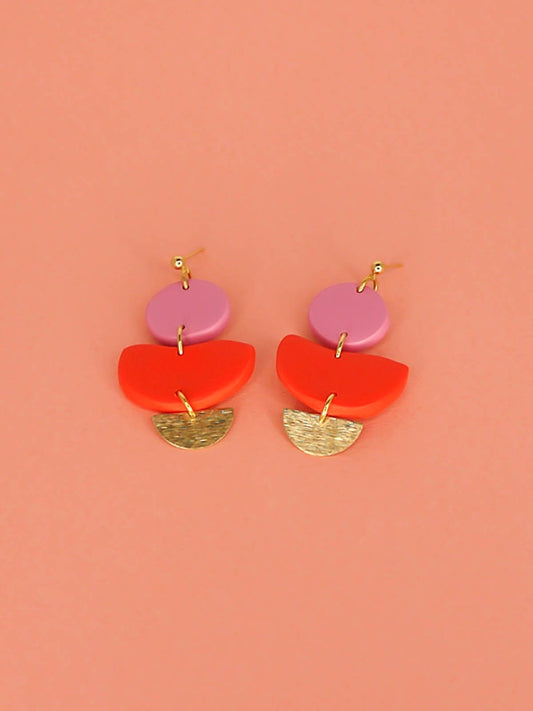 3 tier geometric colour block dangle earrings with gold plated ball studs connected to a fuchsia polymer clay circle & red clay semi circle with a textured brass semi circle charm