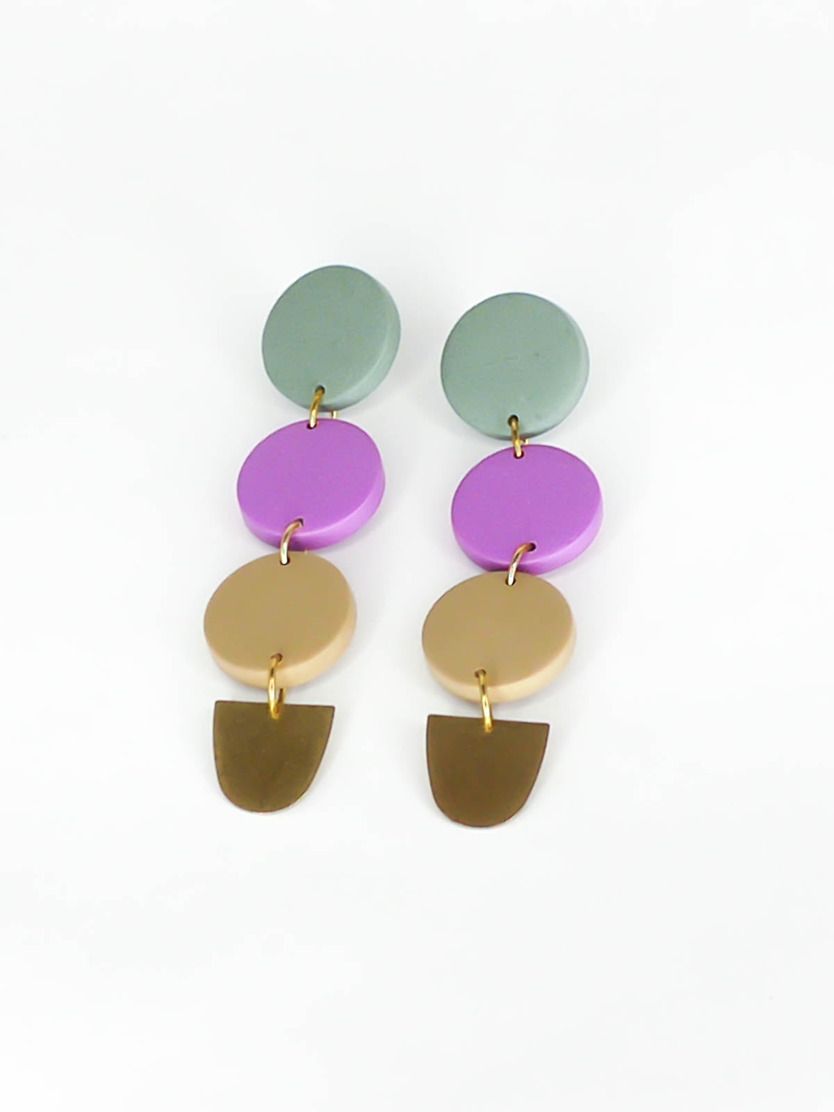 4 tier long colour block circle dangle statement earrings with 3 connected circles made from polymer clay in sage, purple & beige, with a brass semi circle charm dangling on the bottom and stainless steel earring posts.