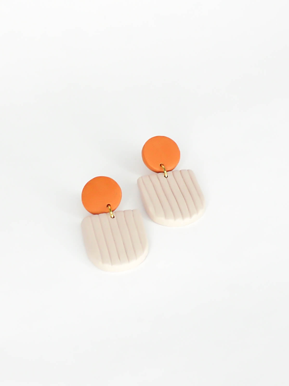 Modern arch dangle statement earrings in beige textured striped arch with a terracotta stud, made out of polymer clay with a stainless steel posts.