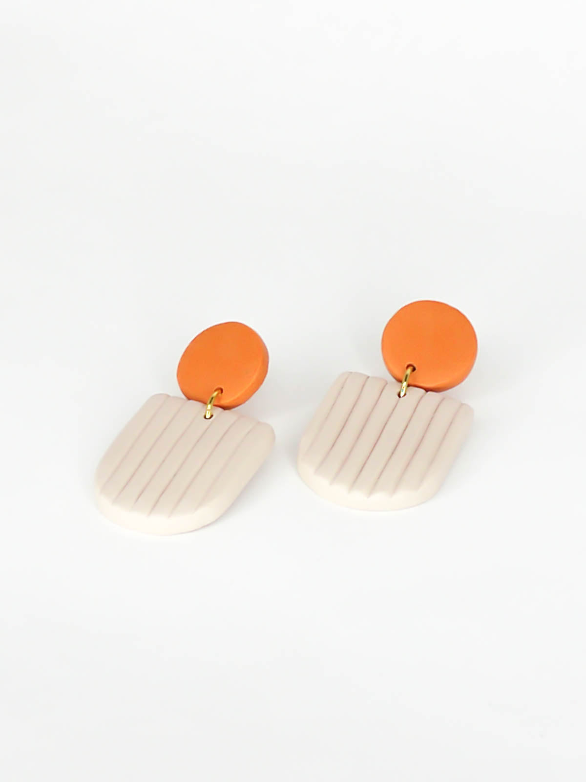 Modern arch dangle statement earrings in beige textured striped arch with a terracotta stud, made out of polymer clay with a stainless steel posts.