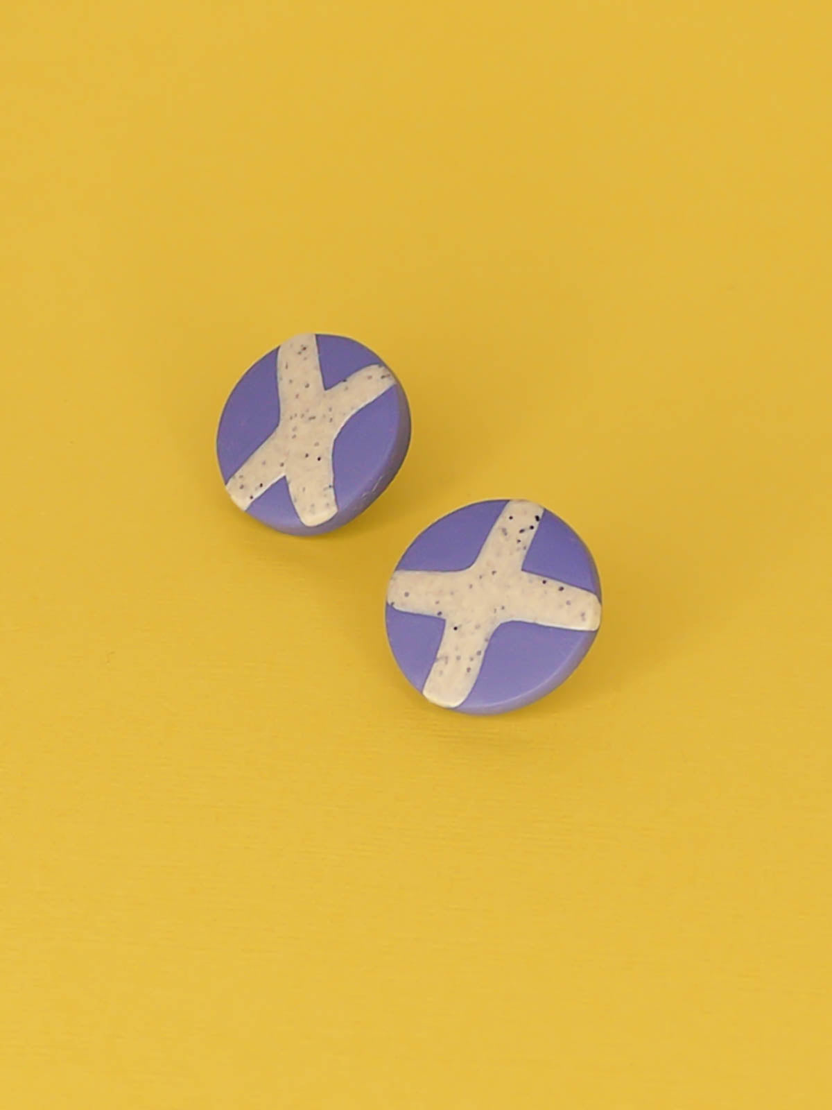 Lightweight geometric periwinkle blue polymer clay stud circle earrings with a granite cross in the centre