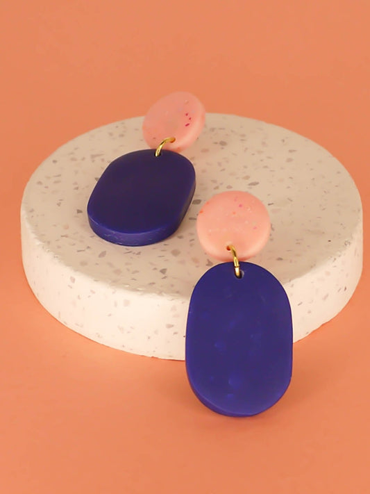 Colour block polymer clay statement earrings with a cobalt blue rectangle and pink speckled stud with stainless steel earring posts