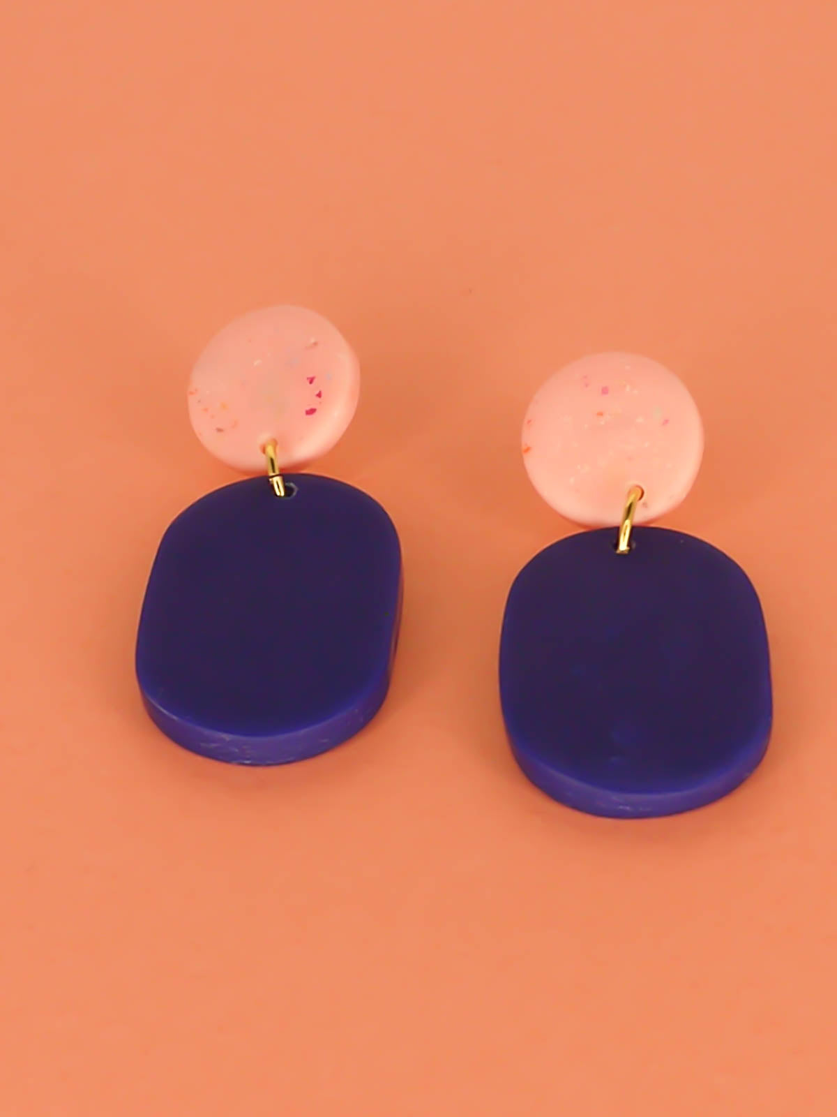 Colour block polymer clay statement earrings with a cobalt blue rectangle and pink speckled stud with stainless steel earring posts