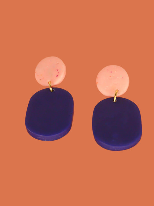 Colour block polymer clay statement earrings with a cobalt blue rectangle and pink speckled stud with stainless steel earring posts
