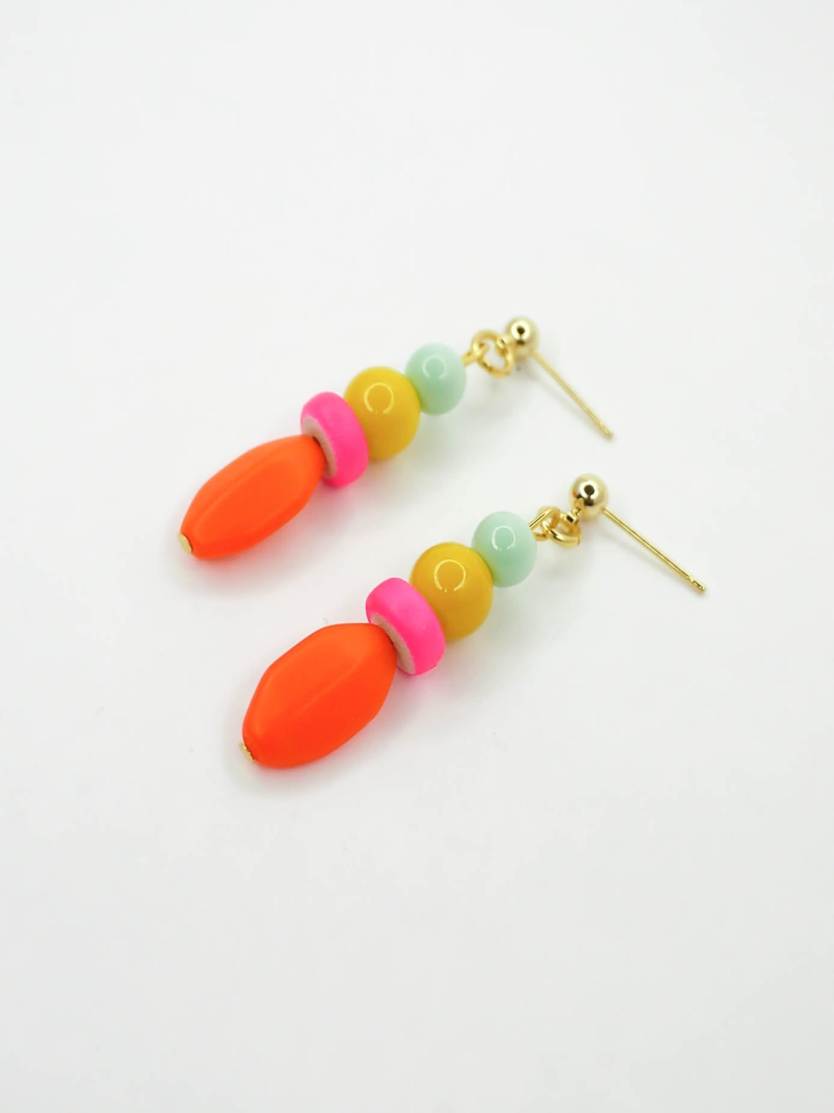 Colourful bright bead drop earrings made of a mix of glass, wood and resin beads in multi colours of mint, yellow, hot pink and orange. Hung from 24k gold plated brass ball studs.