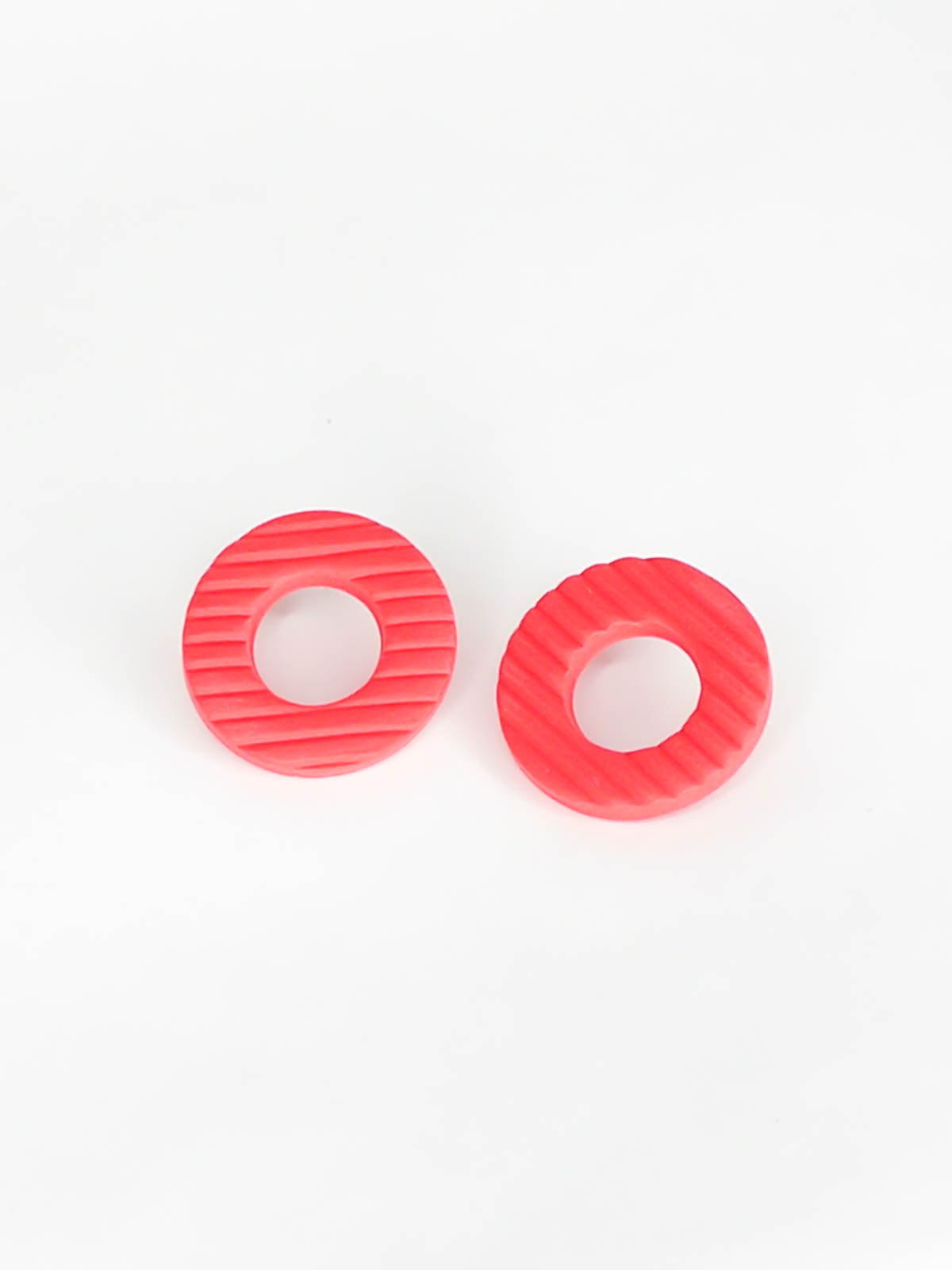 Coral hoop stud statement earrings made out of polymer clay with a fluted striped texture and stainless steel posts