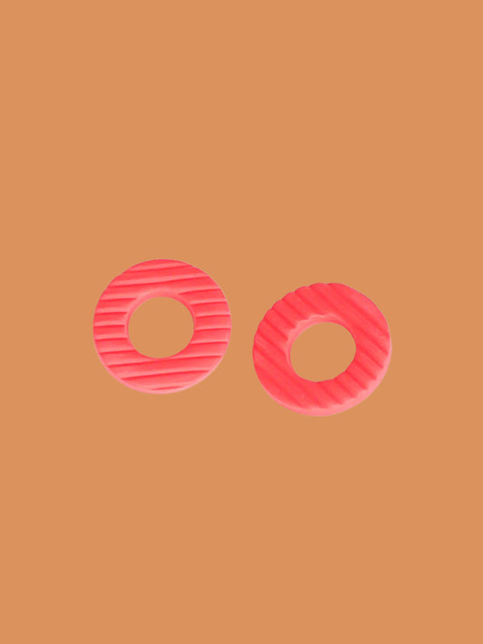 Coral hoop stud statement earrings made out of polymer clay with a fluted striped texture and stainless steel posts
