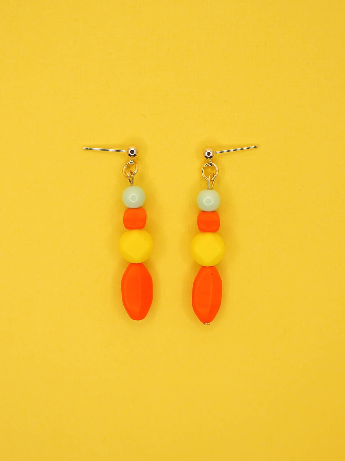 Geometric colour block bead drop earrings in multi coloured resin and glass beads in orange, yellow and mint hung from 24k gold plated brass ball studs.