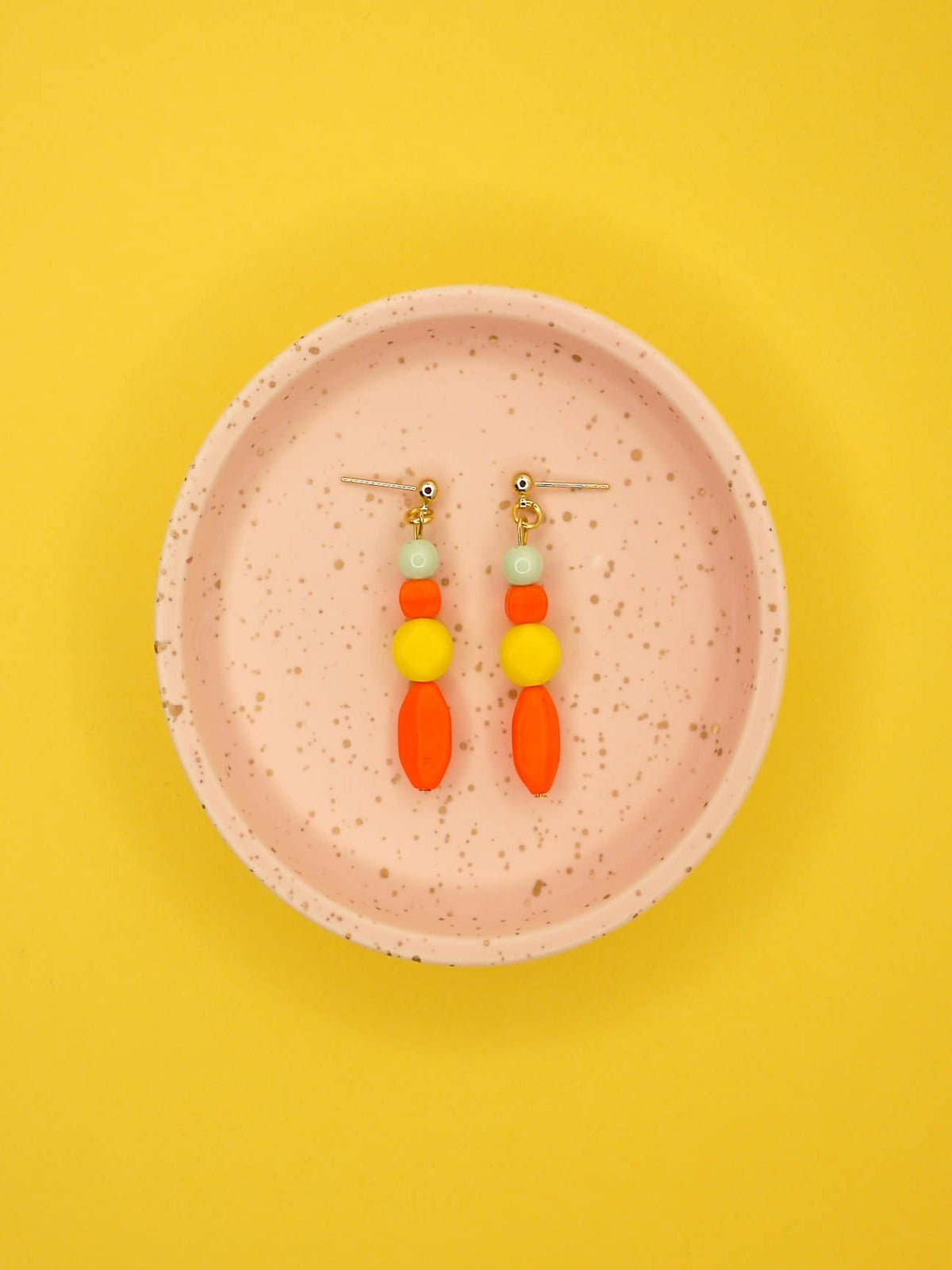 Geometric colour block bead drop earrings in multi coloured resin and glass beads in orange, yellow and mint hung from 24k gold plated brass ball studs.