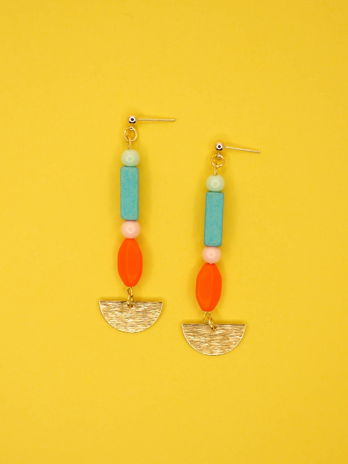 Geometric colourful bead dangle earrings with a textured brass semi circle and beads in ceramic, glass and resin in orange, pink, turquoise and mint. Hung from 24k gold plated brass ball studs.