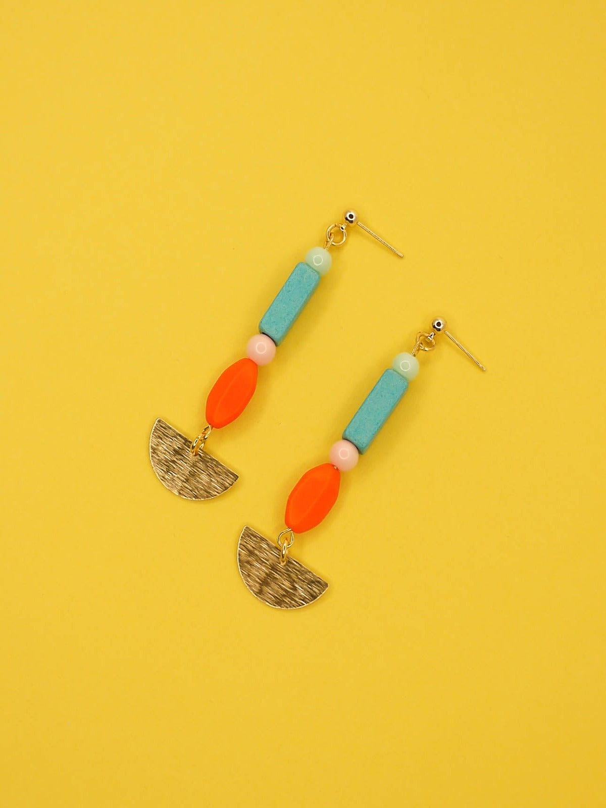 Geometric colourful bead dangle earrings with a textured brass semi circle and beads in ceramic, glass and resin in orange, pink, turquoise and mint. Hung from 24k gold plated brass ball studs.