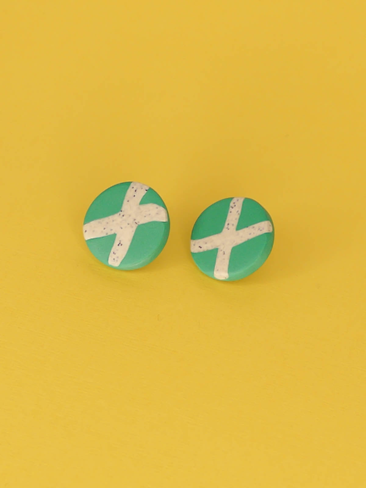 Lightweight geometric green polymer clay stud circle earrings with a granite cross in the centre