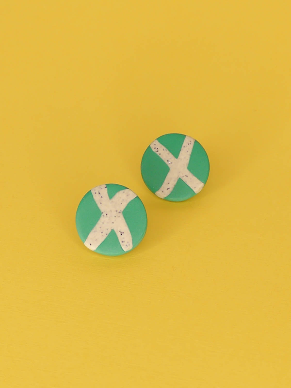 Lightweight geometric green polymer clay stud circle earrings with a granite cross in the centre