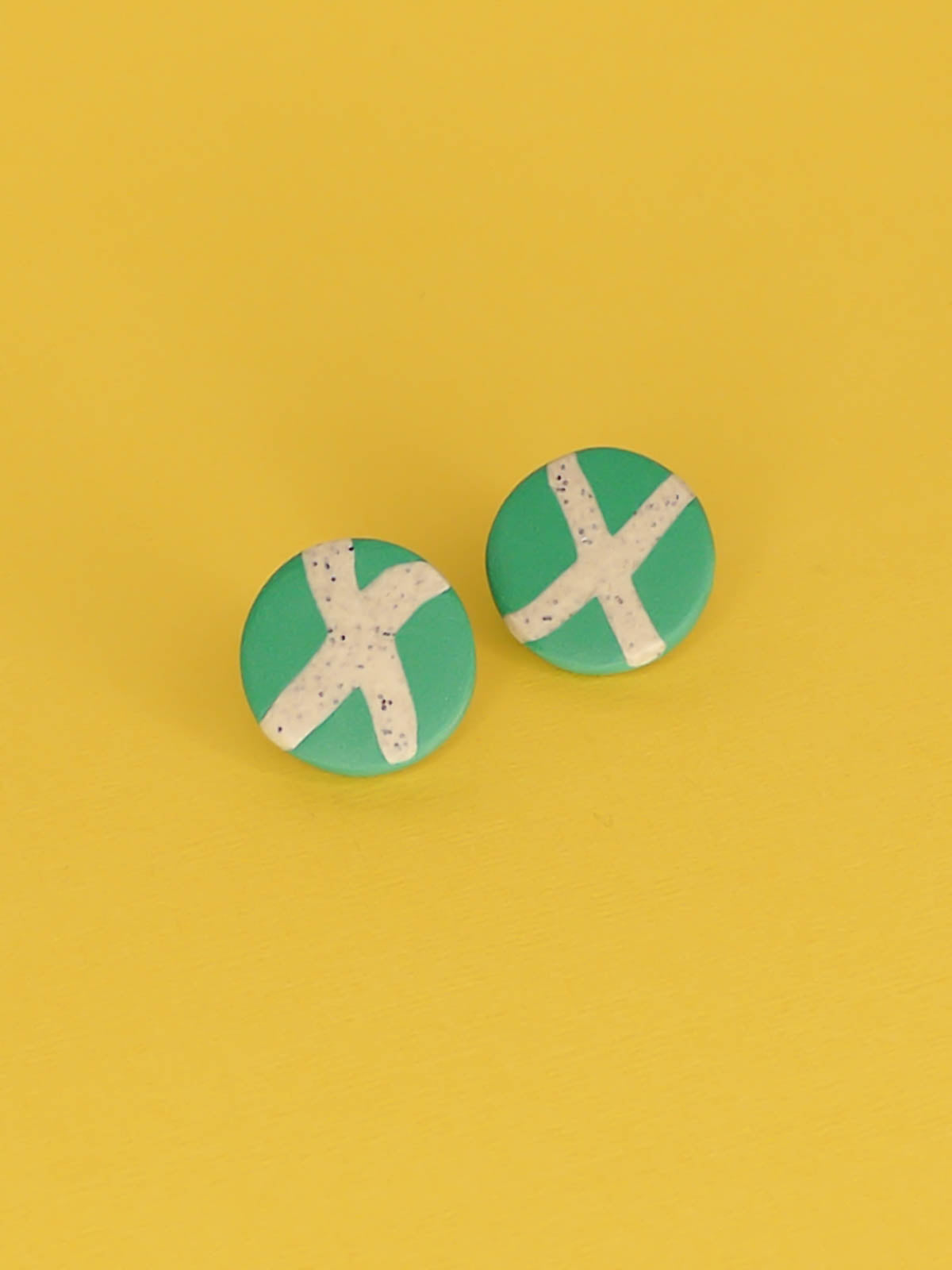 Lightweight geometric green polymer clay stud circle earrings with a granite cross in the centre