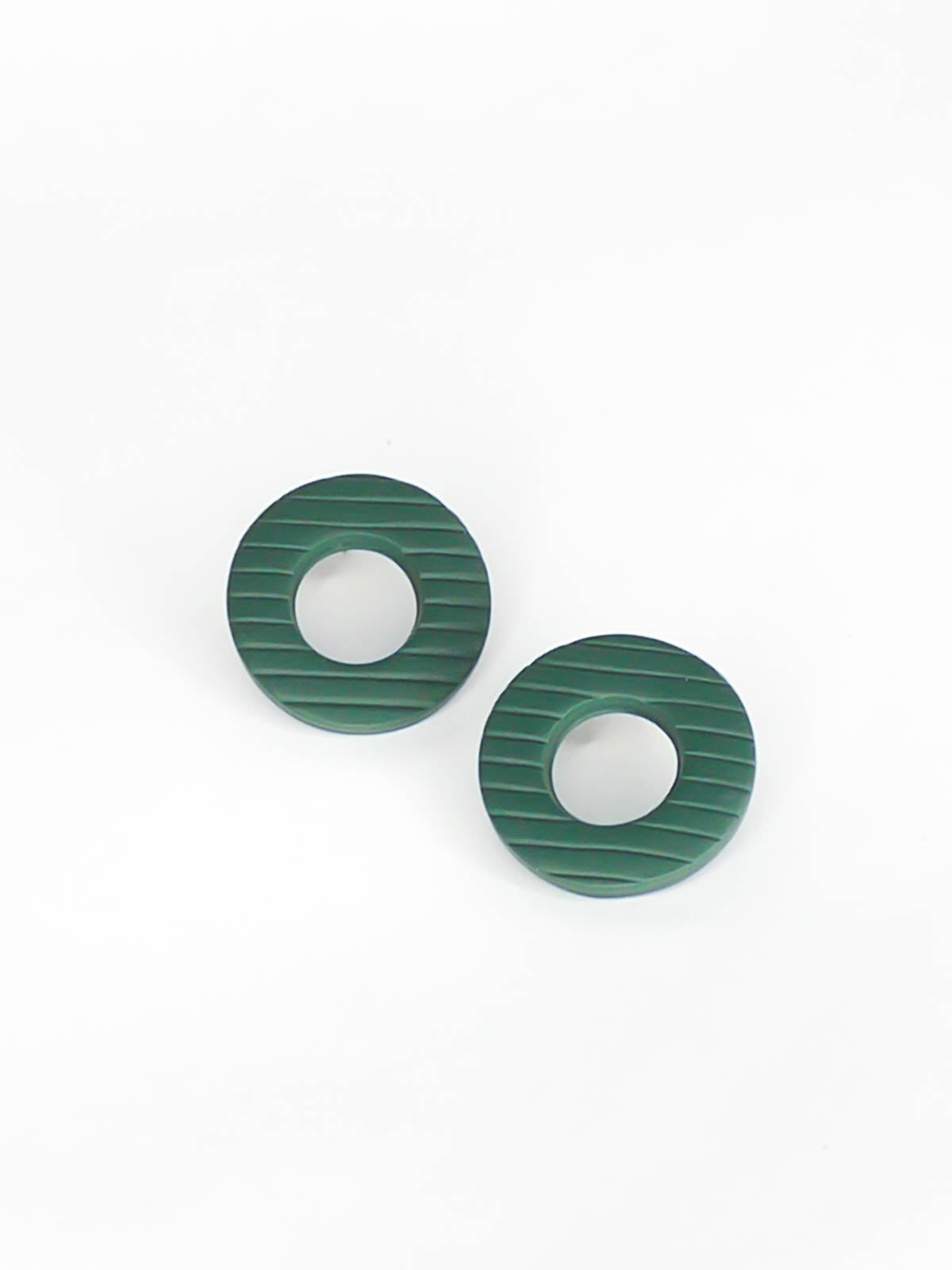 Green hoop stud earrings made out of polymer clay with a striped texture