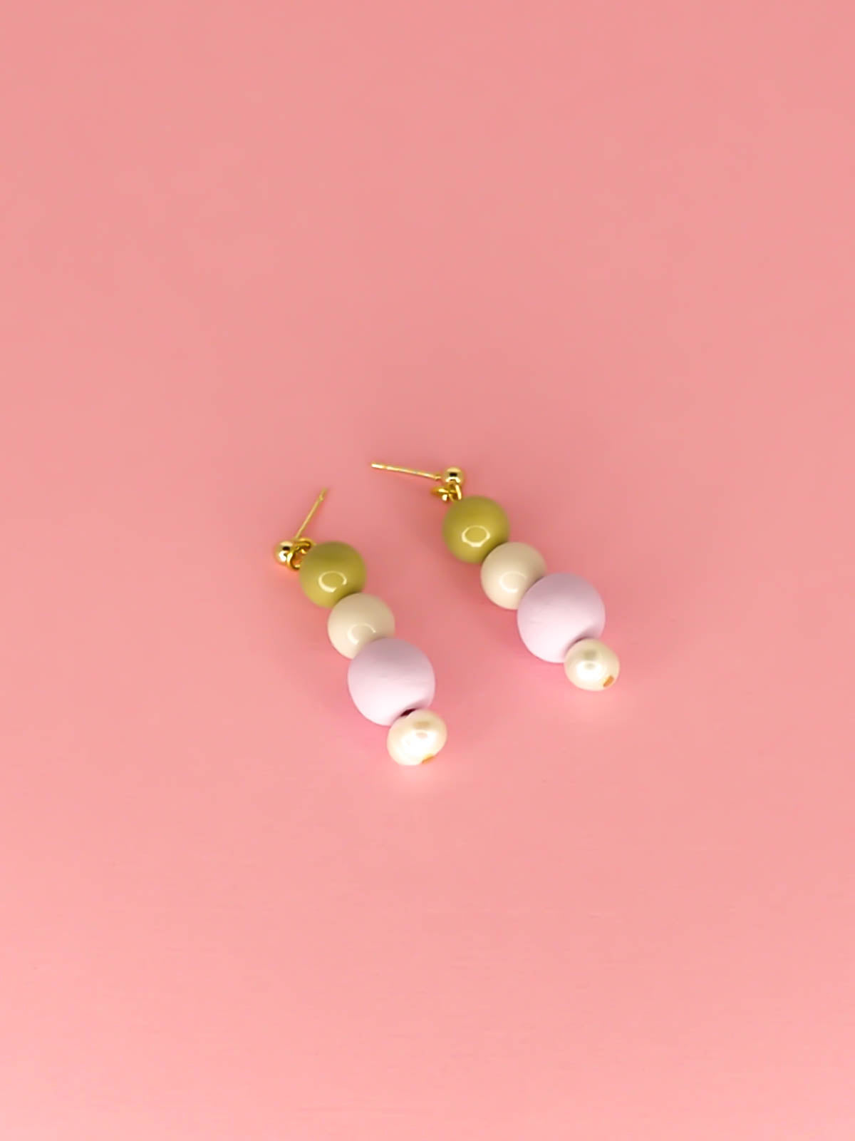 Pastel colour block earrings in green & white glass beads, with a hand rolled polymer clay bead in lilac and a mother of pearl bead, hung from 24k gold plated brass ball studs