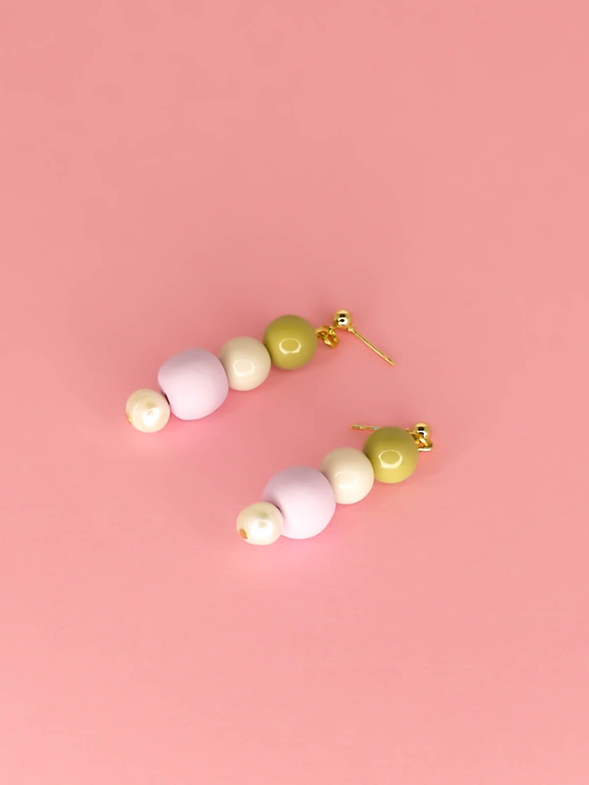 Pastel colour block earrings in green & white glass beads, with a hand rolled polymer clay bead in lilac and a mother of pearl bead, hung from 24k gold plated brass ball studs