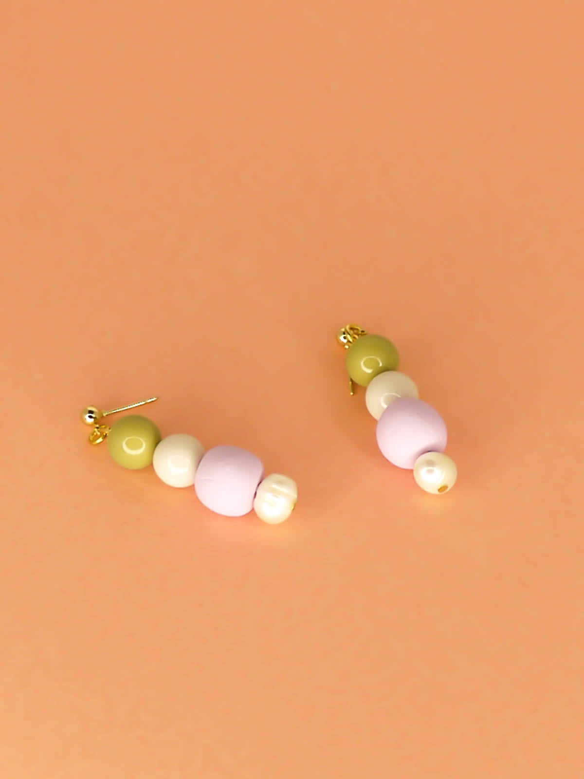 Pastel colour block earrings in green & white glass beads, with a hand rolled polymer clay bead in lilac and a mother of pearl bead, hung from 24k gold plated brass ball studs