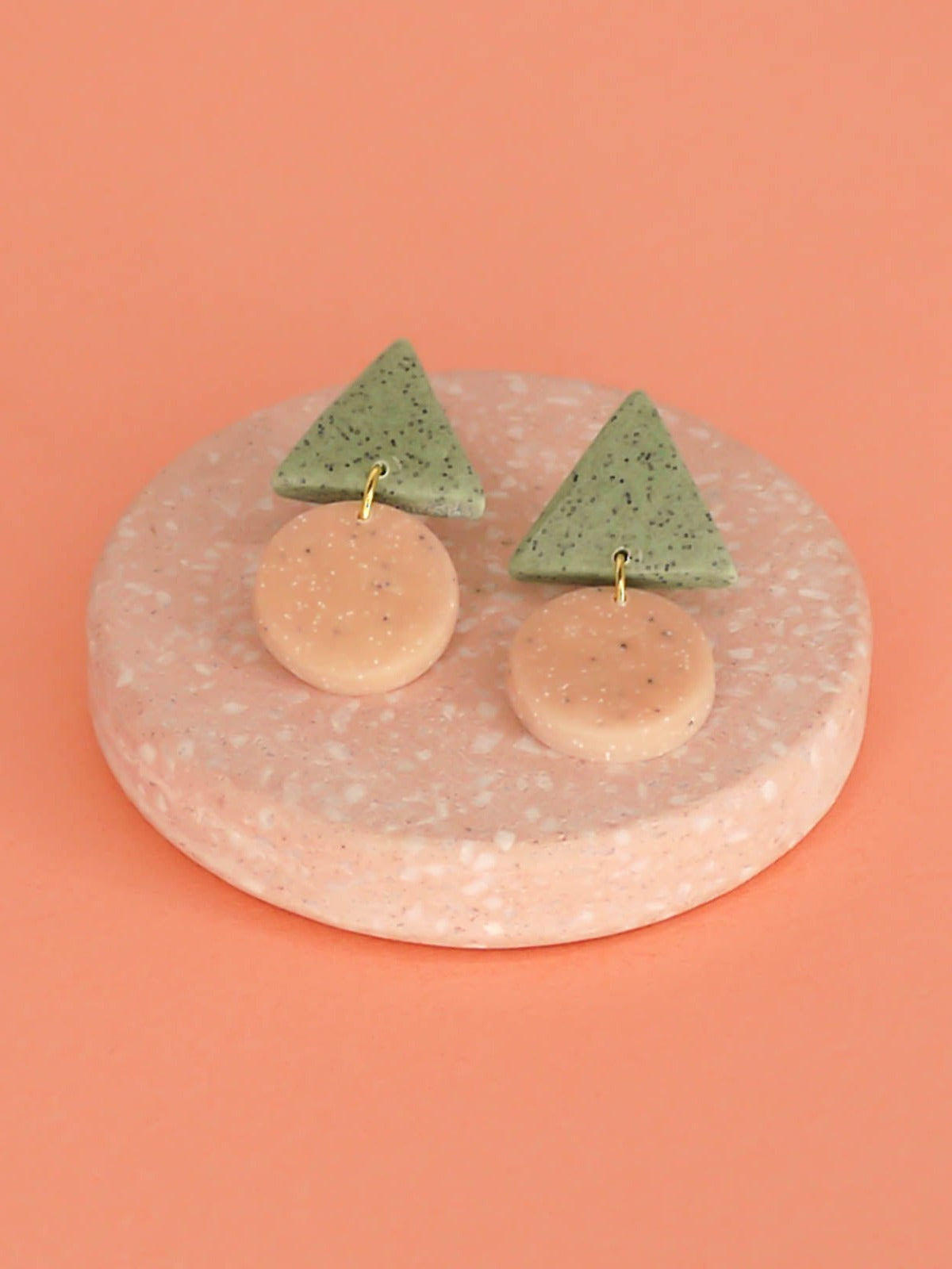 Geometric stud dangle earrings with a granite green triangle stud and a peach granite circle with stainless steel posts