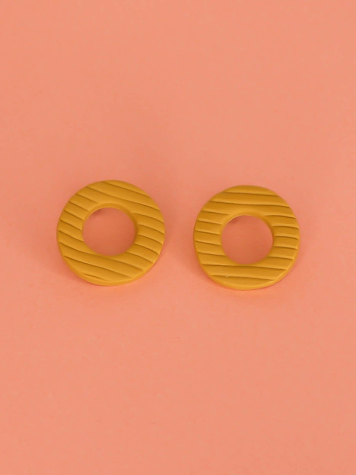 Mustard hoop stud statement earrings made out of polymer clay with a fluted striped texture and stainless steel posts