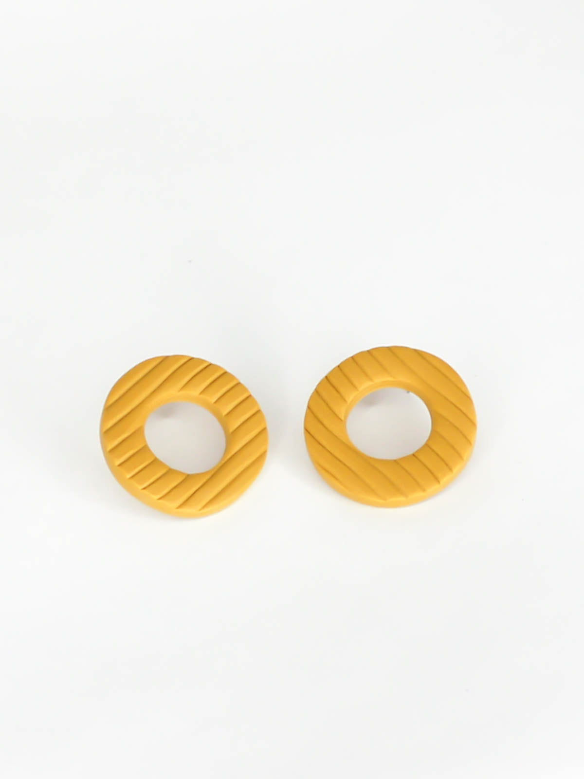 Mustard hoop stud statement earrings made out of polymer clay with a fluted striped texture and stainless steel posts