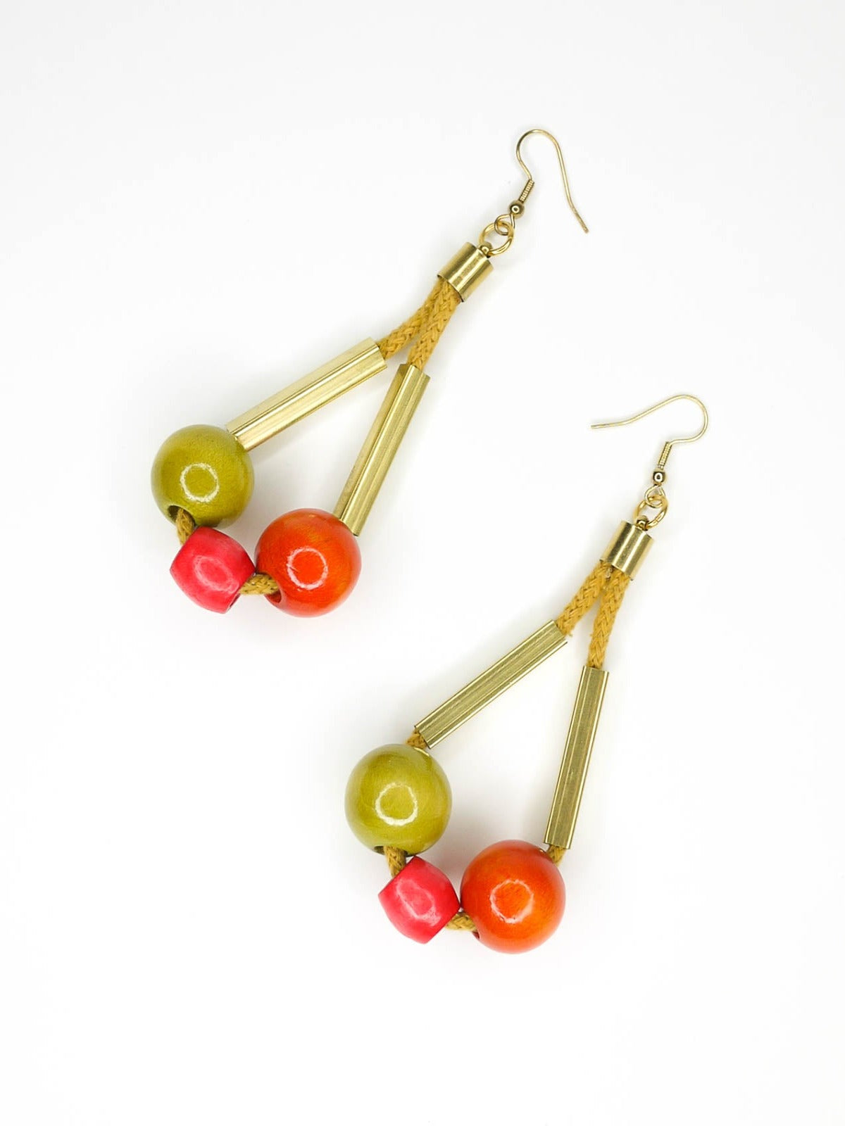 Long bead dangle statement earrings with wooden beads in watermelon, orange & green & brass tube beads strung on mustard coloured cotton rope with brass end caps, hung from gold plated brass earring hooks.