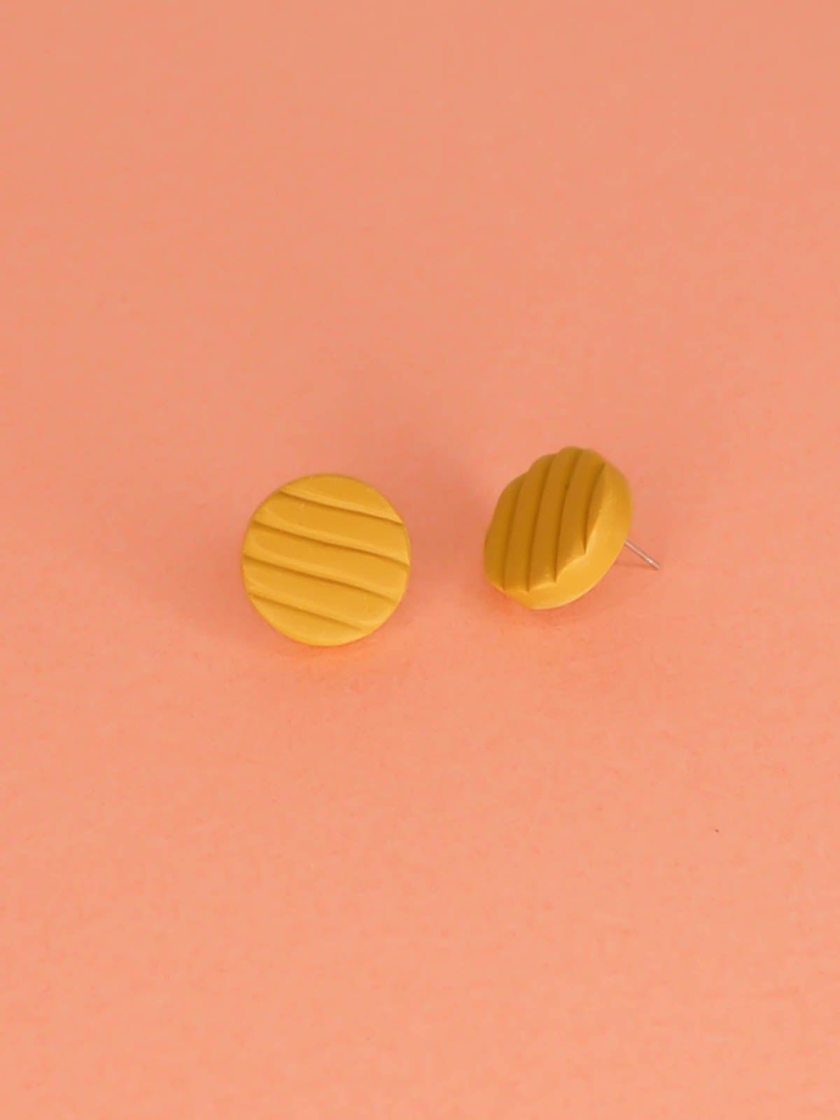 Mini mustard polymer clay studs in a textured stripe