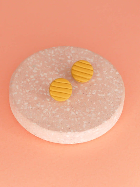 Mini mustard polymer clay studs in a textured stripe