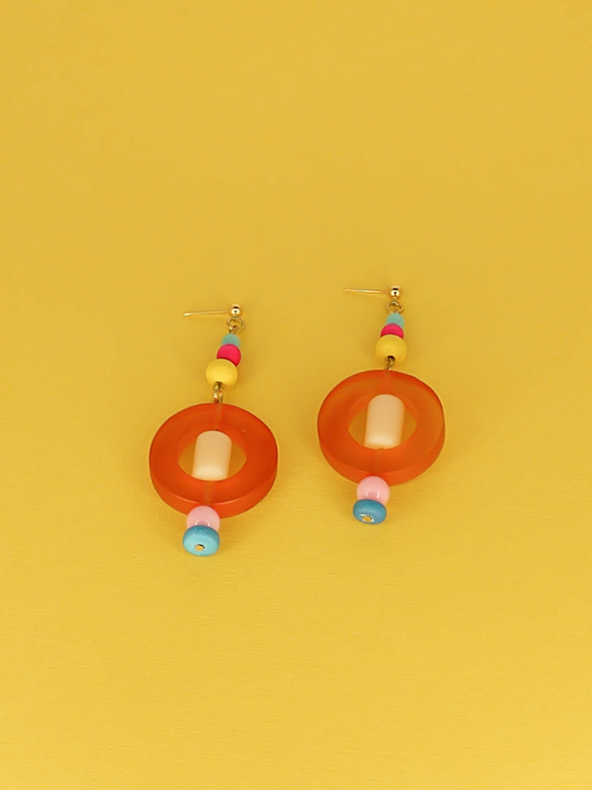 Colourful lightweight hoop bead earrings with glass & wood beads in yellow, pink & turquoise with a resin orange hoop in the centre & a resin cream tube bead in the middle. Hung from 24k gold plated ball studs.