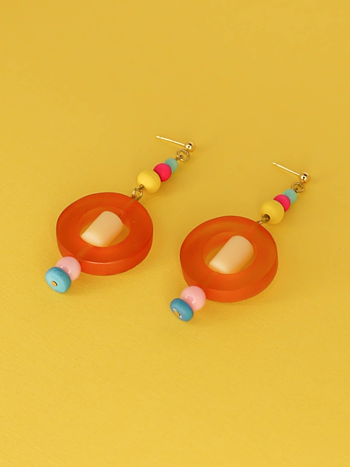 Colourful lightweight hoop bead earrings with glass & wood beads in yellow, pink & turquoise with a resin orange hoop in the centre & a resin cream tube bead in the middle. Hung from 24k gold plated ball studs.