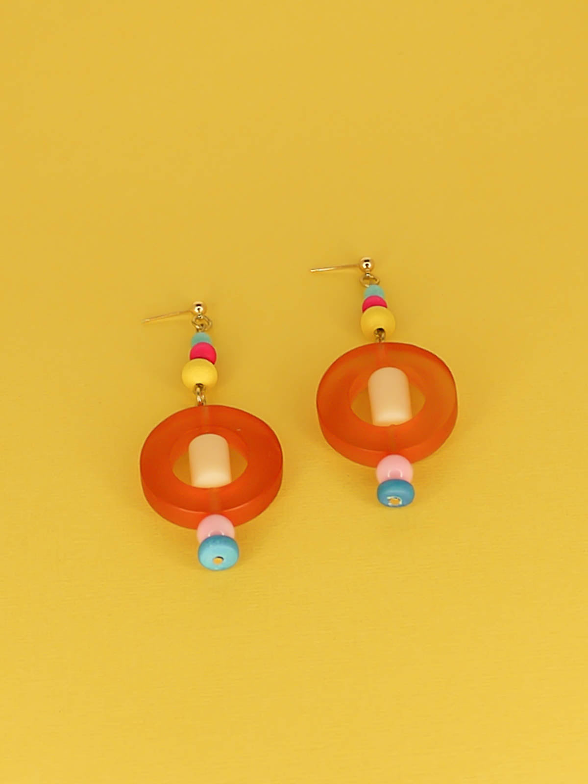 Colourful lightweight hoop bead earrings with glass & wood beads in yellow, pink & turquoise with a resin orange hoop in the centre & a resin cream tube bead in the middle. Hung from 24k gold plated ball studs.