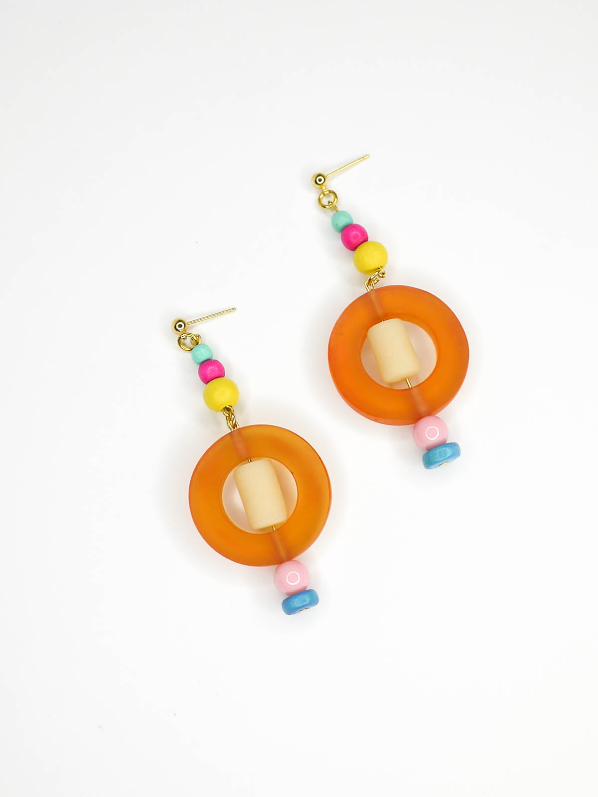 Colourful lightweight hoop bead earrings with glass & wood beads in yellow, pink & turquoise with a resin orange hoop in the centre & a resin cream tube bead in the middle. Hung from 24k gold plated ball studs.