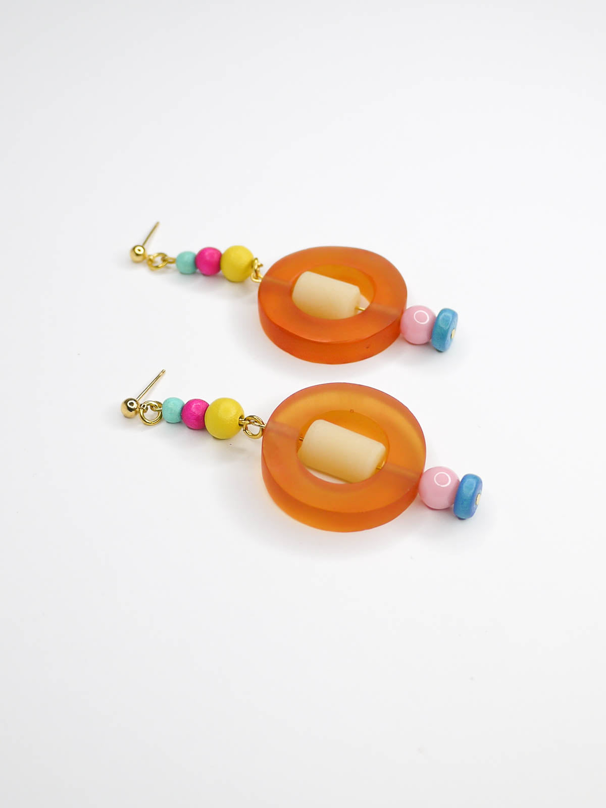 Colourful lightweight hoop bead earrings with glass & wood beads in yellow, pink & turquoise with a resin orange hoop in the centre & a resin cream tube bead in the middle. Hung from 24k gold plated ball studs.