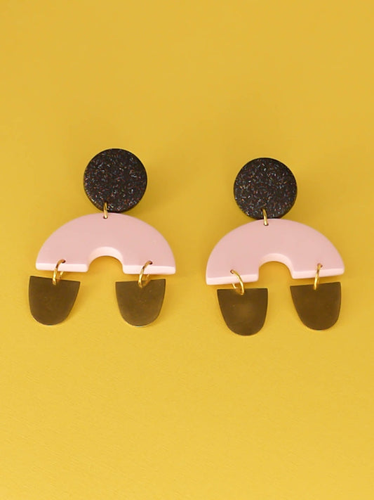 Large geometric arch dangle chandelier earrings with a black glitter stud, connected to a pink semi circle with two brass semi circles hanging off either side of the arch. Made from polymer clay with stainless steel posts.