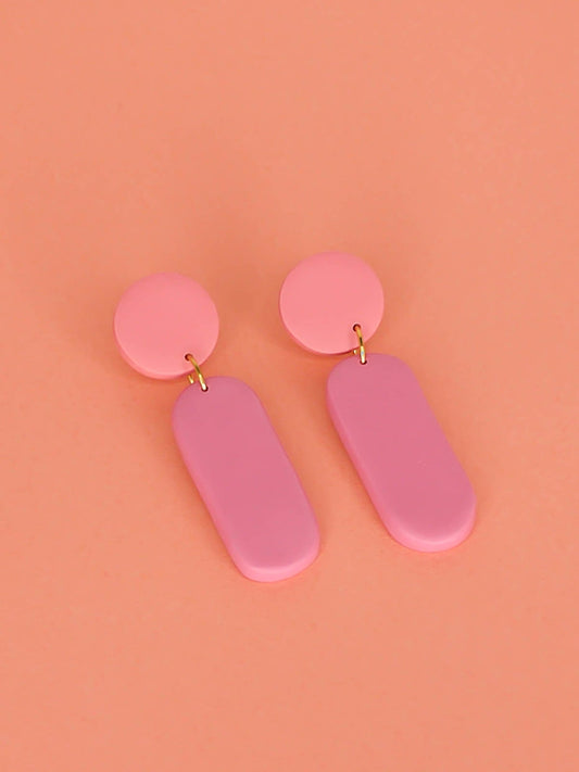 Pink colour block dangle stick earrings in two tones of pink with a long rectangle and circle disk made out of lightweight polymer clay