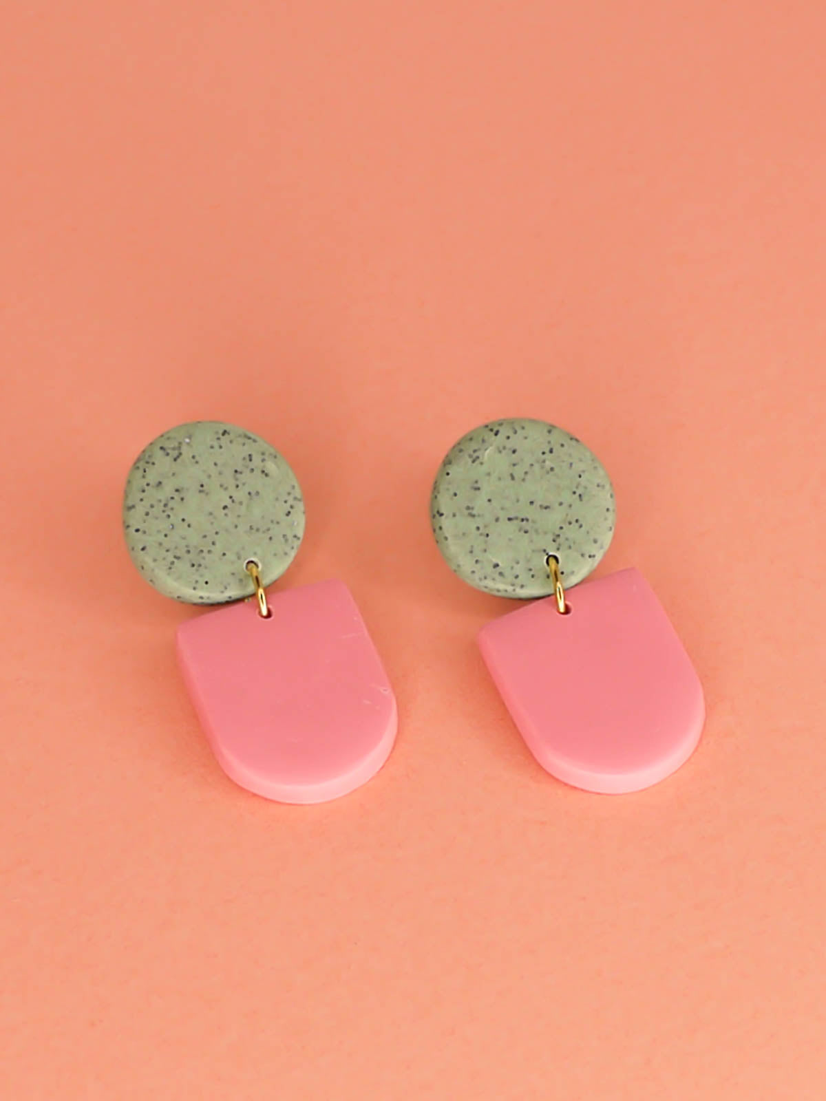 Lightweight statement arch dangle earrings with a pink arch and green granite stud, with stainless steel posts, handmade out of polymer clay