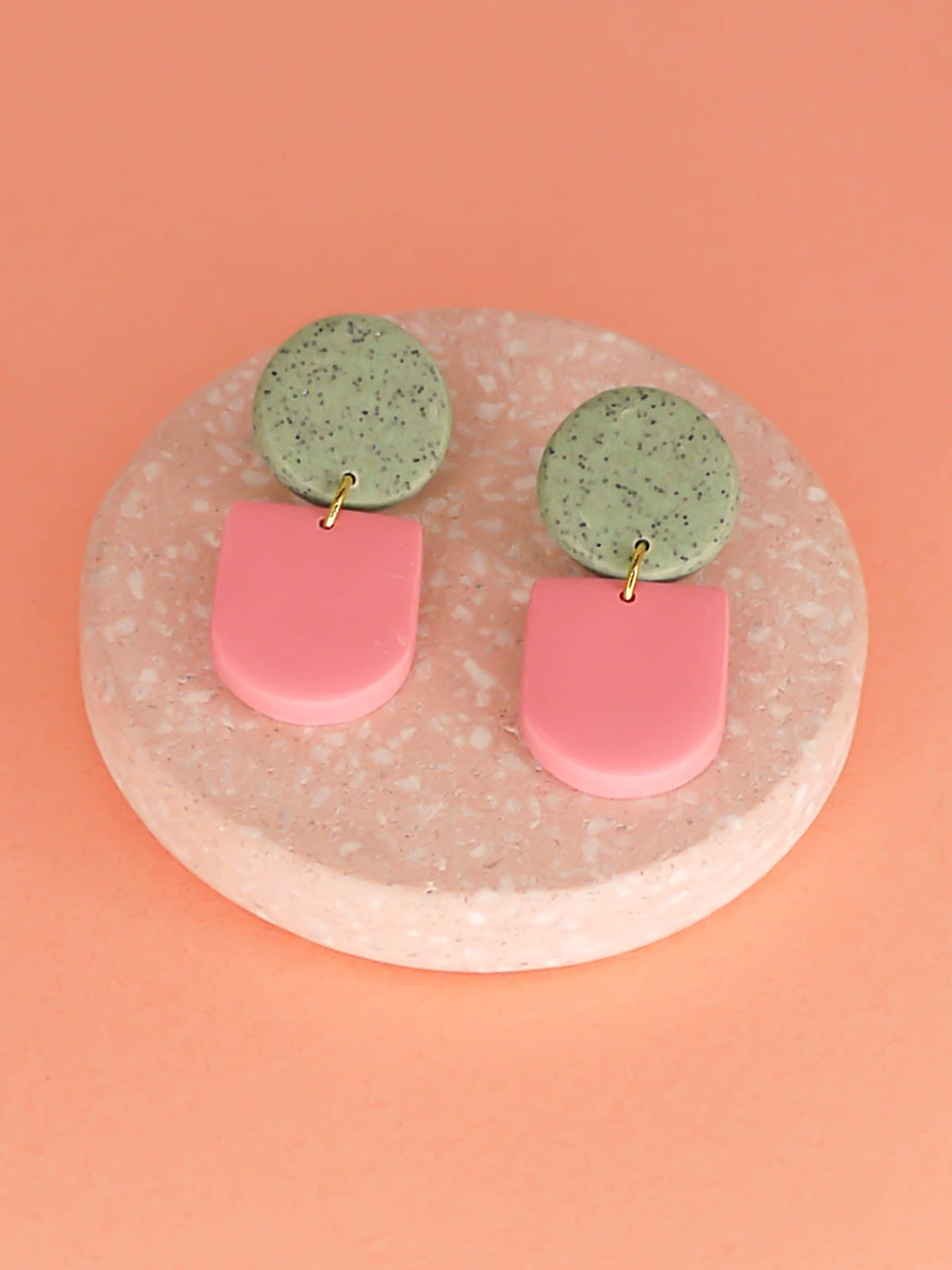 Lightweight statement arch dangle earrings with a pink arch and green granite stud, with stainless steel posts, handmade out of polymer clay