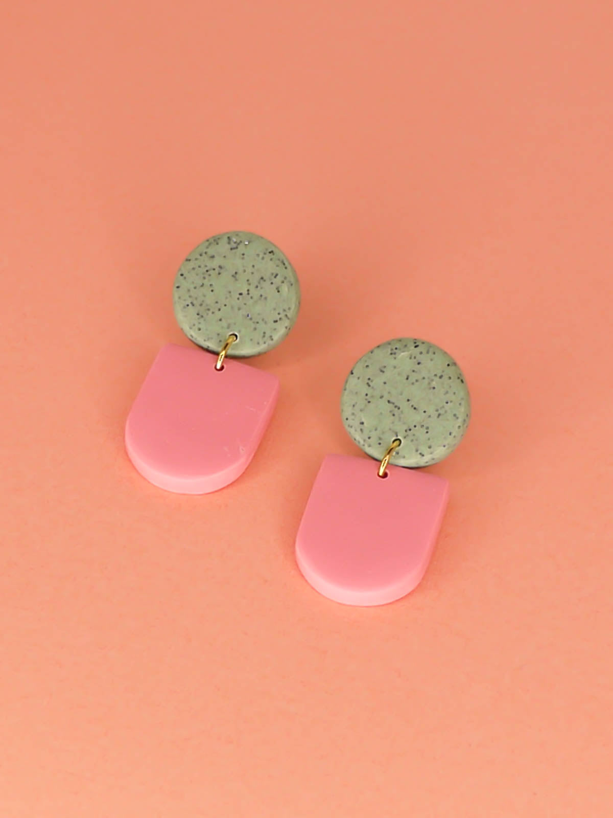 Lightweight statement arch dangle earrings with a pink arch and green granite stud, with stainless steel posts, handmade out of polymer clay