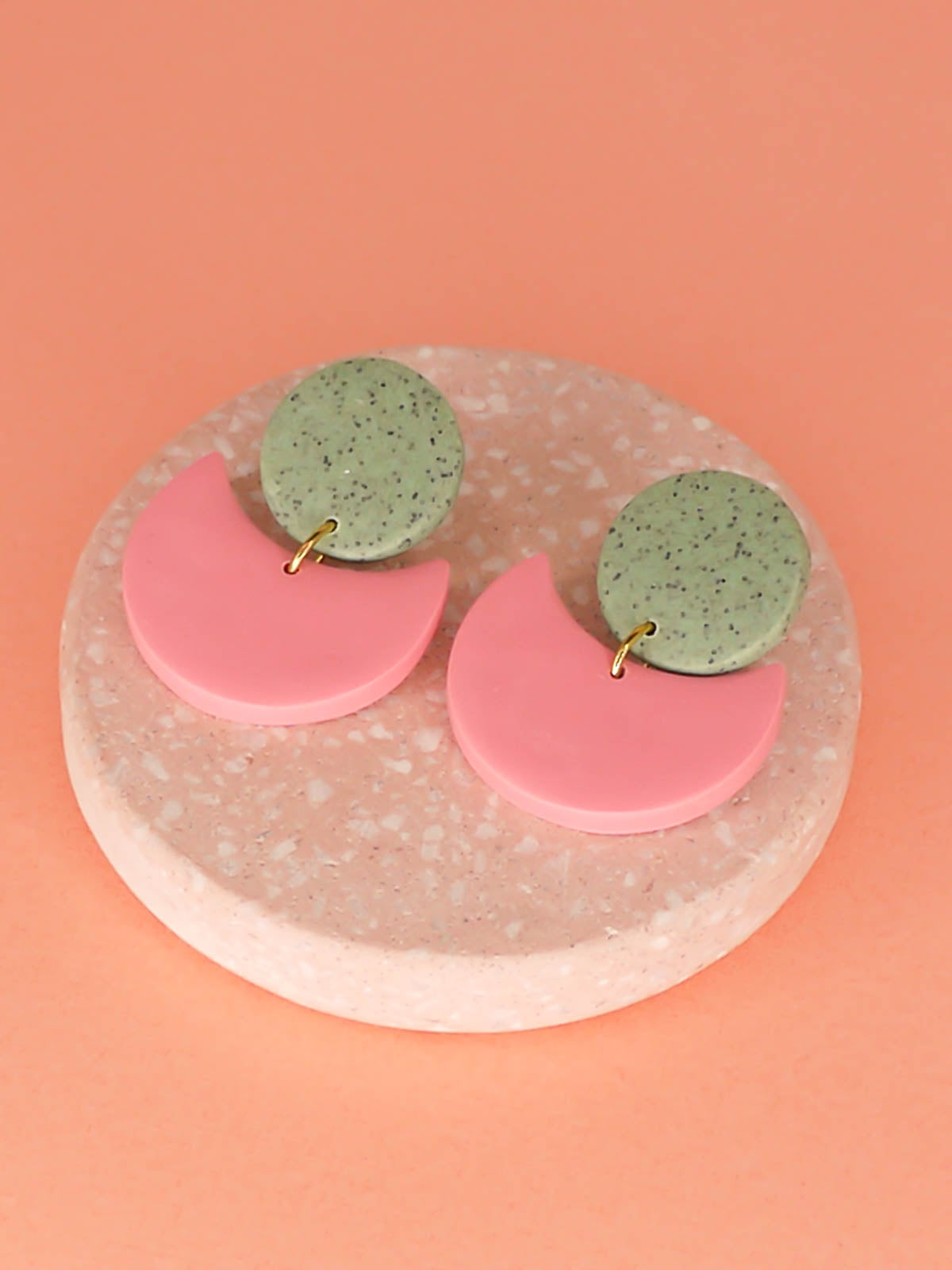 Geometric pink & green crescent statement earrings with a green granite stud and a pink semi circle, with stainless steel posts, handmade from polymer clay.