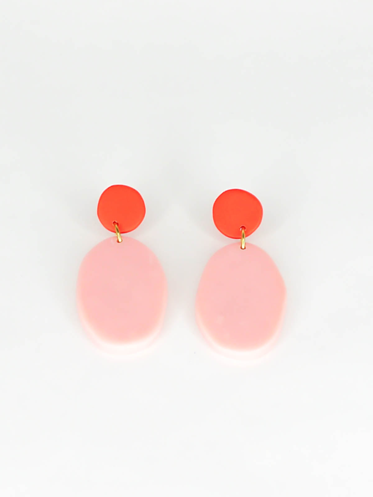 Colour block polymer clay pebble earrings in pink with a red stud and stainless steel posts