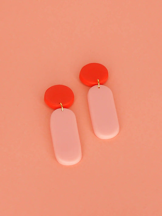 Statement dangle earrings with a rectangle pink stick dangle and red stud, with stainless steel posts, made out of lightweight polymer clay