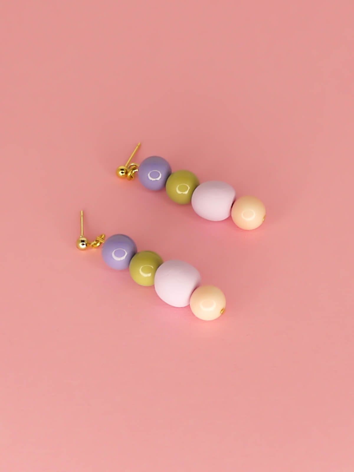 Pastel colour block bead drop earrings in purple, green & pink glass beads with a hand rolled lilac polymer clay bead hung from 24k gold plated ball studs