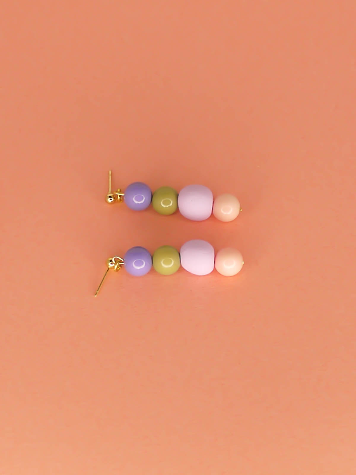 Pastel colour block bead drop earrings in purple, green & pink glass beads with a hand rolled lilac polymer clay bead hung from 24k gold plated ball studs