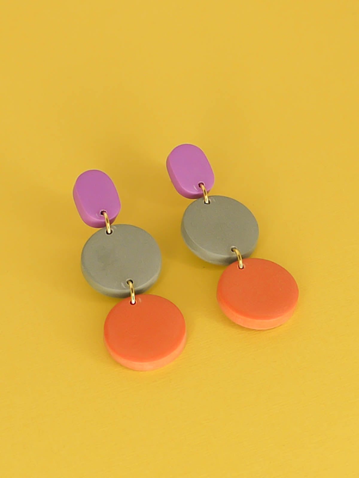 Colour block 3-tier polymer clay dangle earrings in a purple rectangle stud, connected to a sage & orange circle