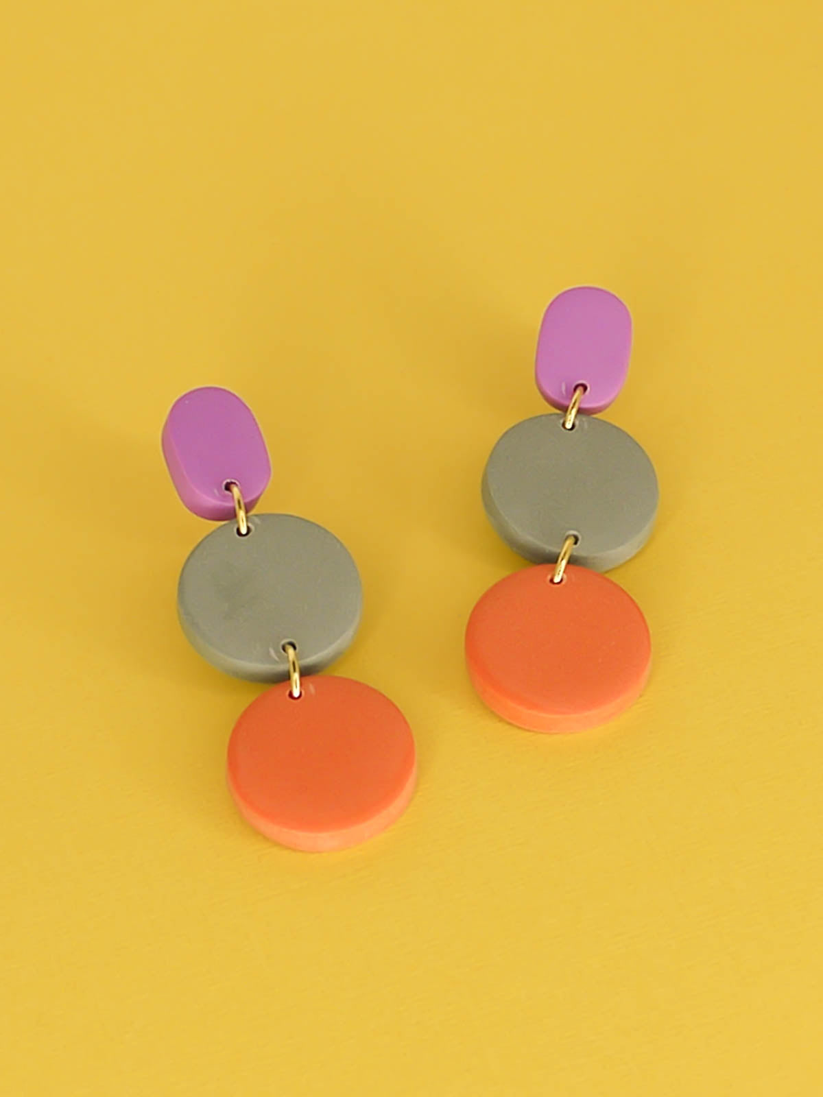 Colour block 3-tier polymer clay dangle earrings in a purple rectangle stud, connected to a sage & orange circle