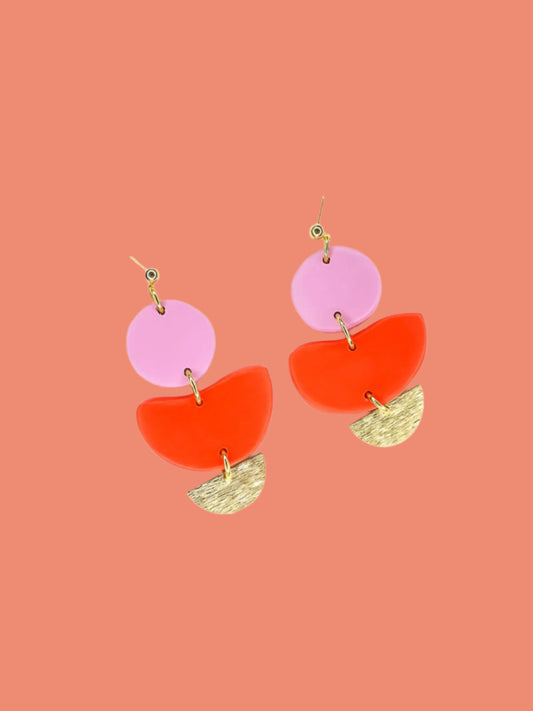 3 tier geometric colour block dangle earrings with gold plated ball studs connected to a fuchsia polymer clay circle & red clay semi circle with a textured brass semi circle charm