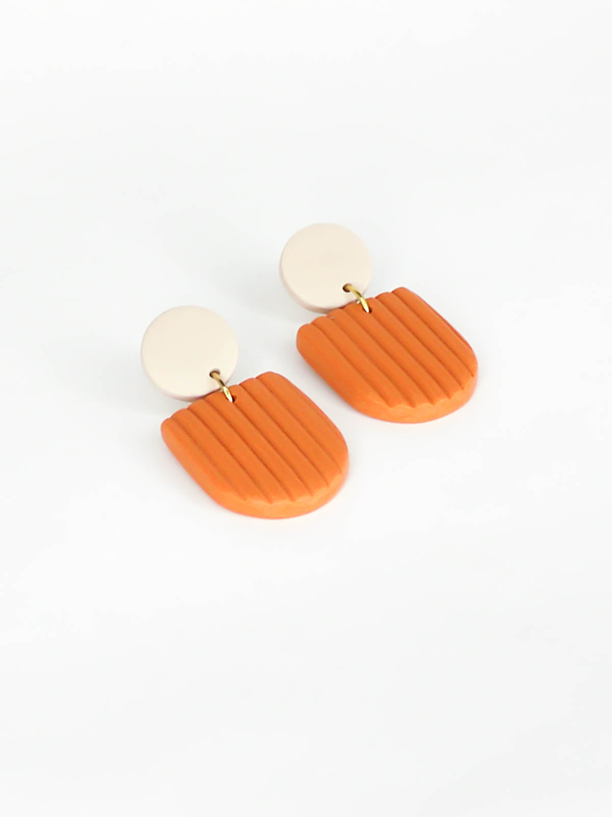 Modern arch dangle statement earrings in terracotta textured striped arch with a beige stud, made out of polymer clay with a stainless steel posts.