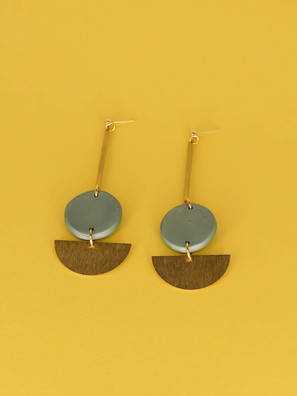 Dangle geometric statement earrings with a gold plated ball stud, a brass stick with a polymer clay round metallic circle in turquoise connected to a textured brass semi circle