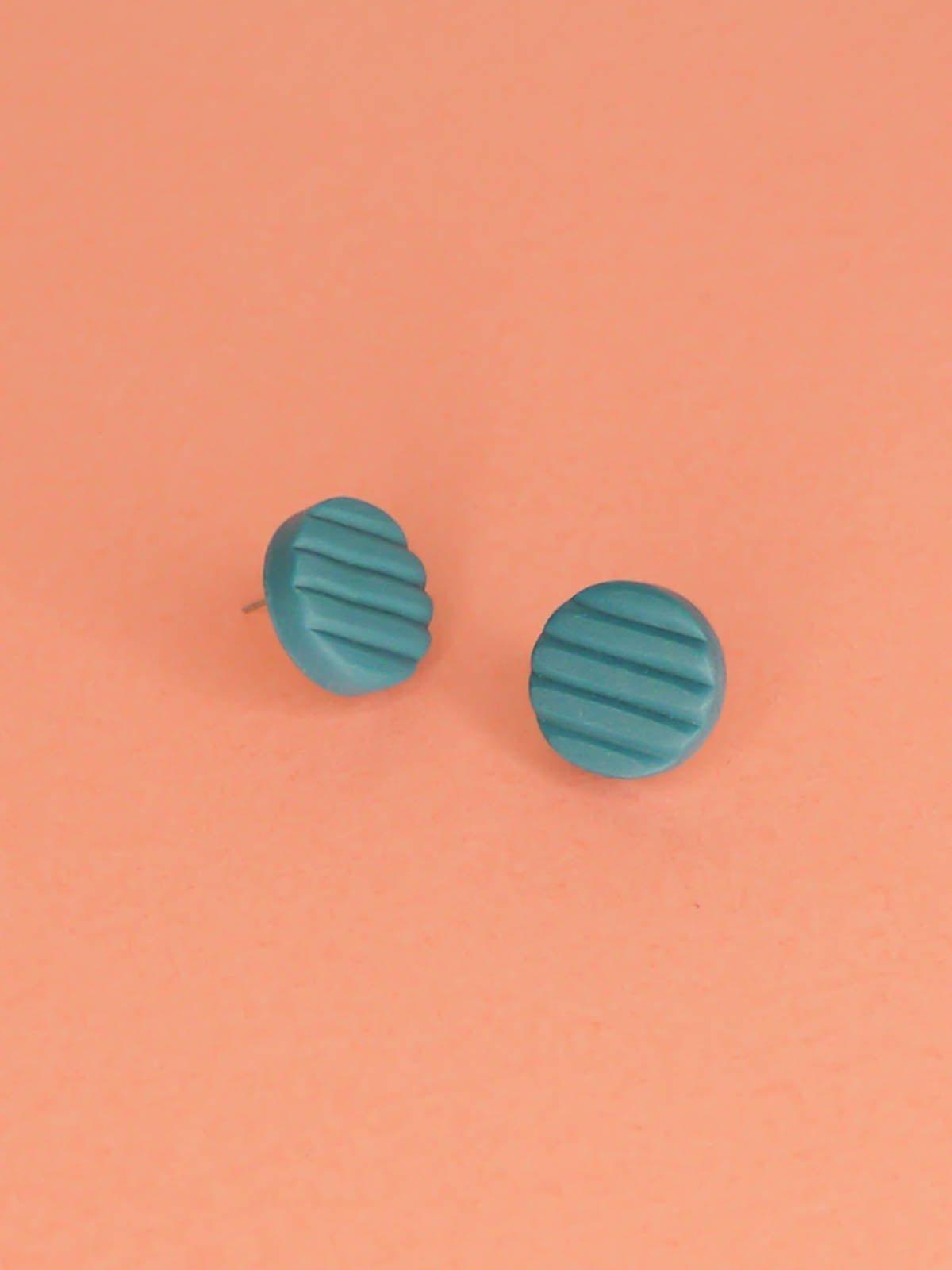 Mini turquoise polymer clay studs in a textured stripe