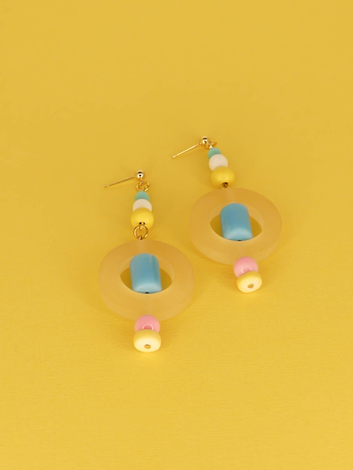 Colourful lightweight hoop bead earrings with glass & wood beads in yellow, pink & turquoise with a resin yellow hoop in the centre & a resin blue tube bead in the middle. Hung from 24k gold plated ball studs.